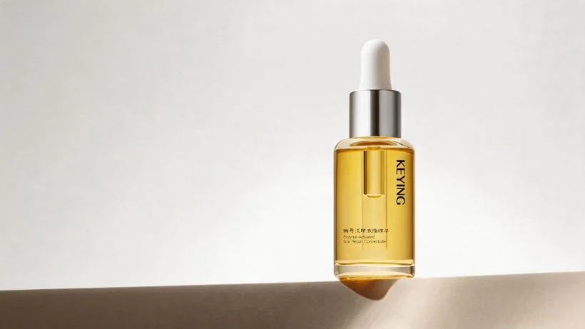 A KEYING serum in amber glass, photographed in natural light